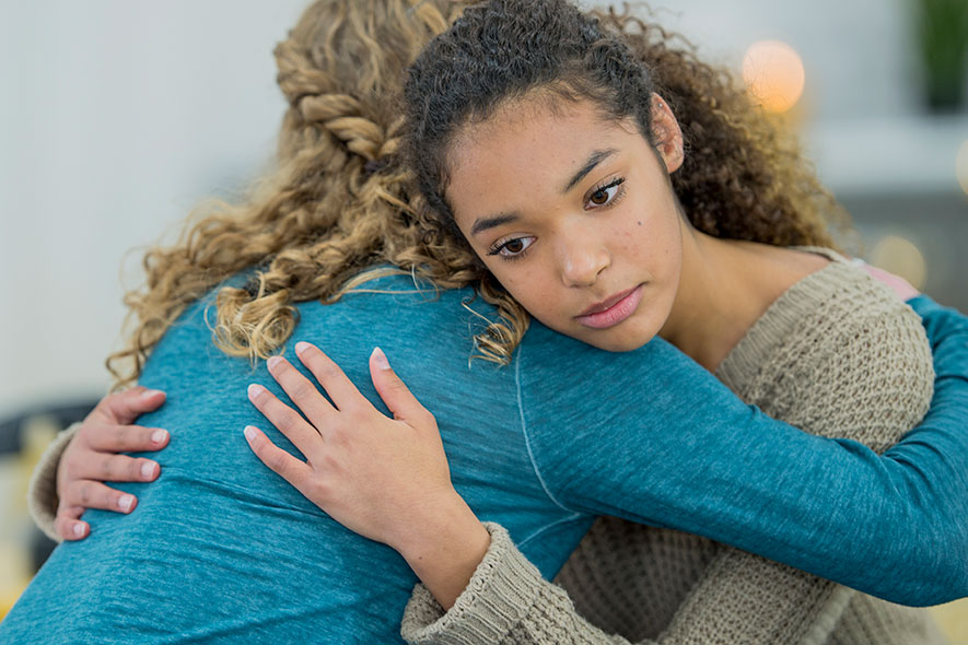 young girl and woman hugging